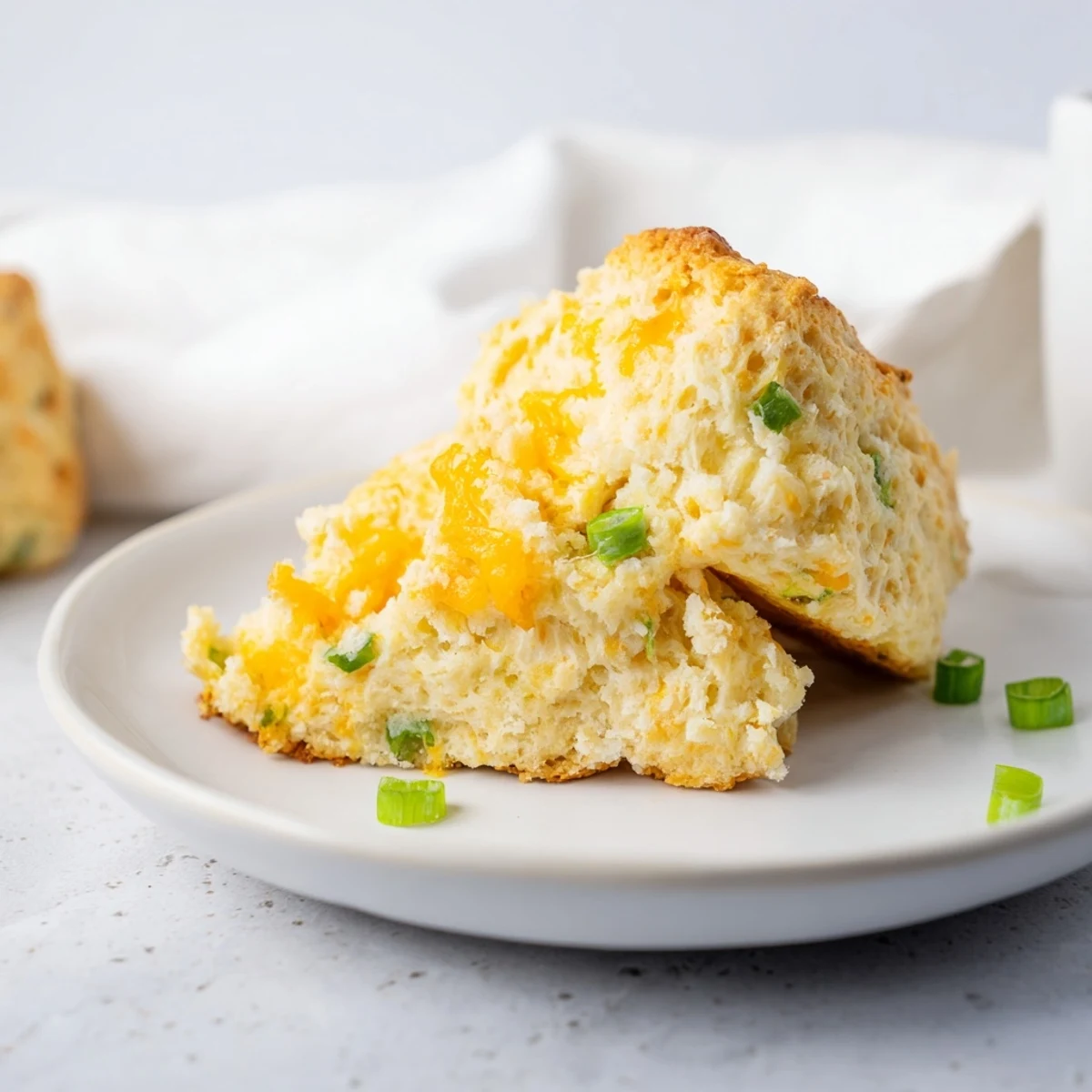 Golden, cheesy savory scones, fresh from the oven, with a crispy, flaky exterior and soft insides.