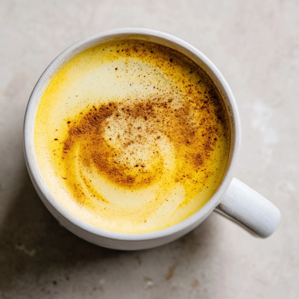 Enjoy a soothing cup of Spiced Golden Milk Latte, richly flavored with warm spices and a touch of sweetness.