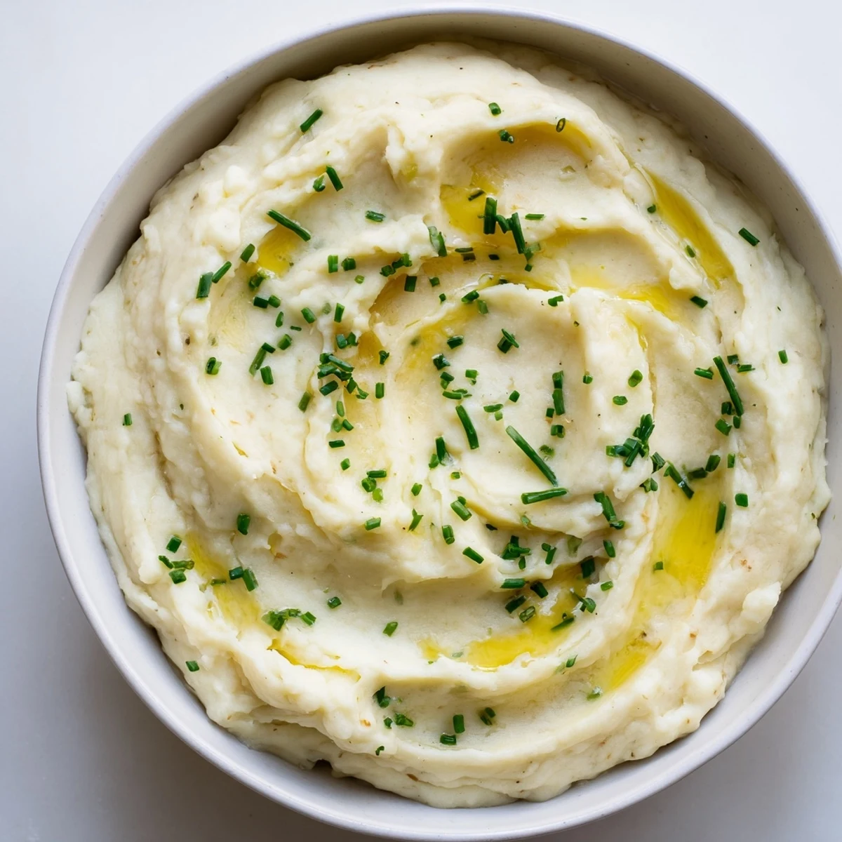 Golden-roasted garlic enhances these Garlic Mashed Potatoes, a flavorful, homemade American classic dish.