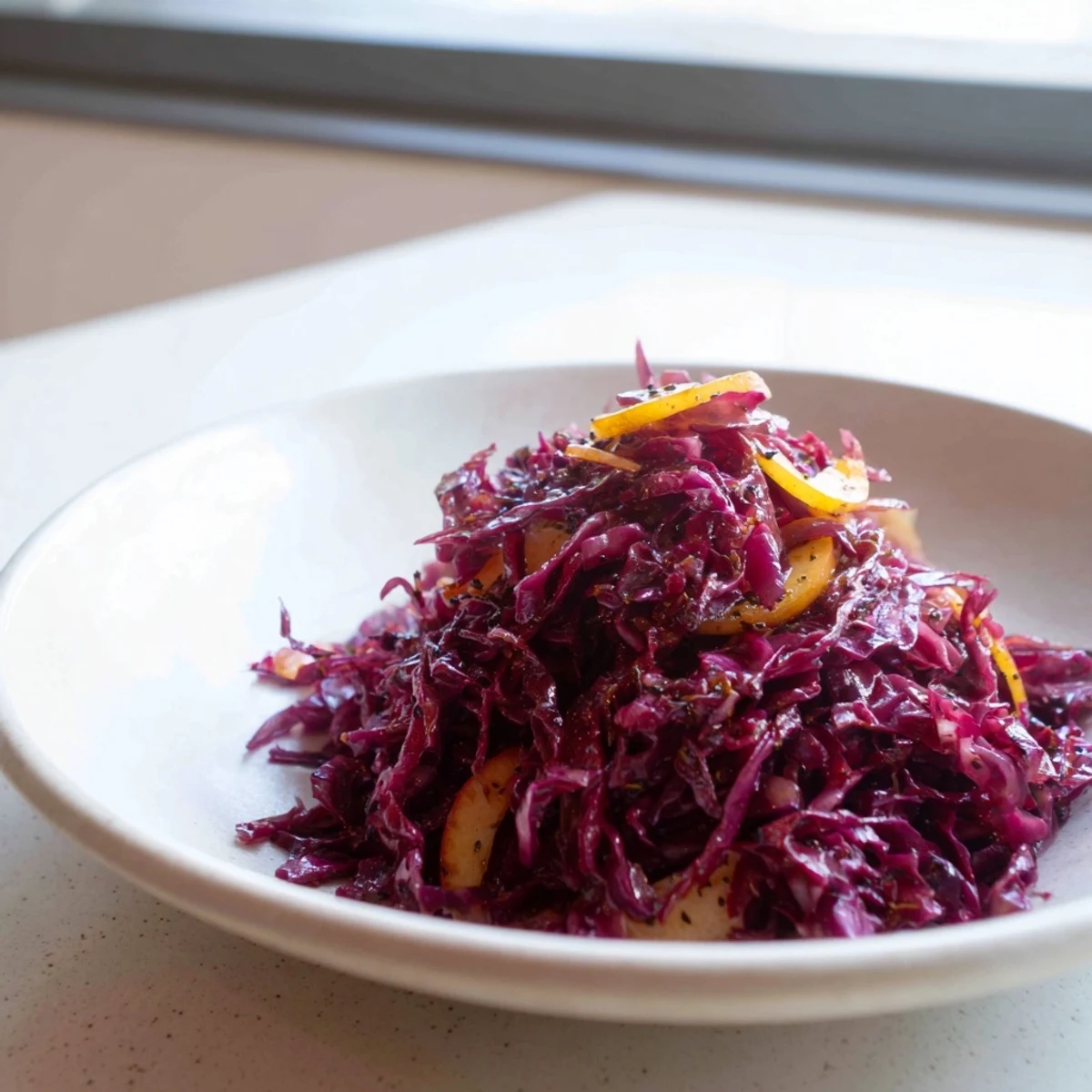 Tender, glistening Braised Red Cabbage with Apple, a beautiful side dish ready to be served.