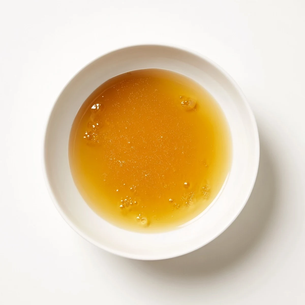 Golden brown beef stock pot simmering with aromatic vegetables for a hearty meal.