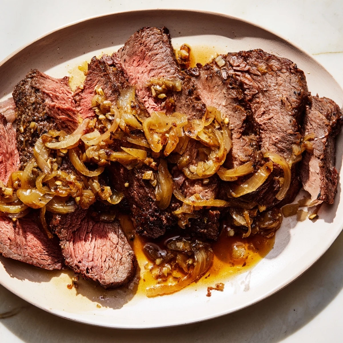 A close-up shot of fork-tender braised brisket with onions, offering a symphony of savory flavors and textures.