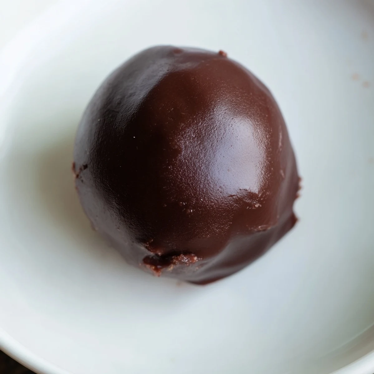 Close-up of decadent Cookie Dough Truffles, coated in rich chocolate, ready to enjoy as a sweet treat.