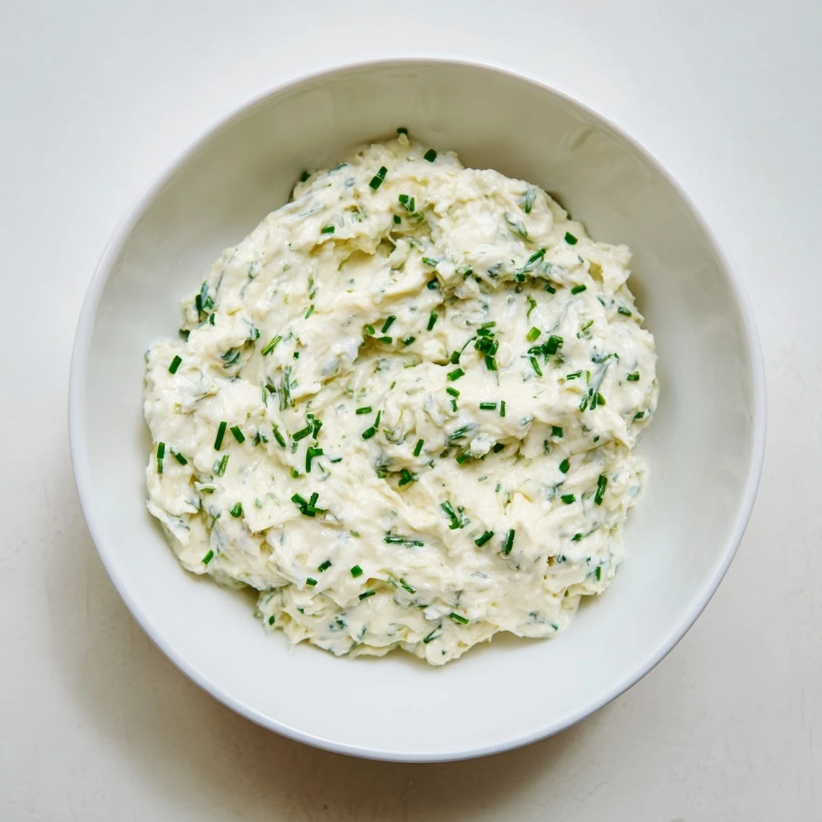 Creamy garlic dip, perfect for dipping, showcases fresh herbs and a vibrant, inviting texture.