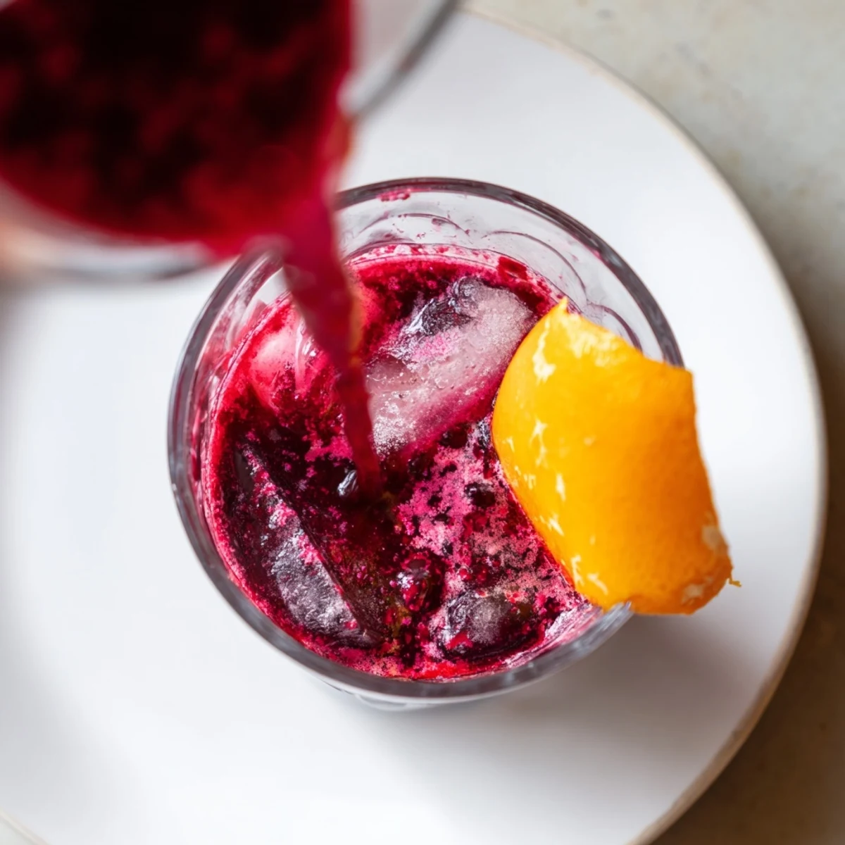Bright red and purple Winter Berry Juice, chilled and ready to serve on a hot day.