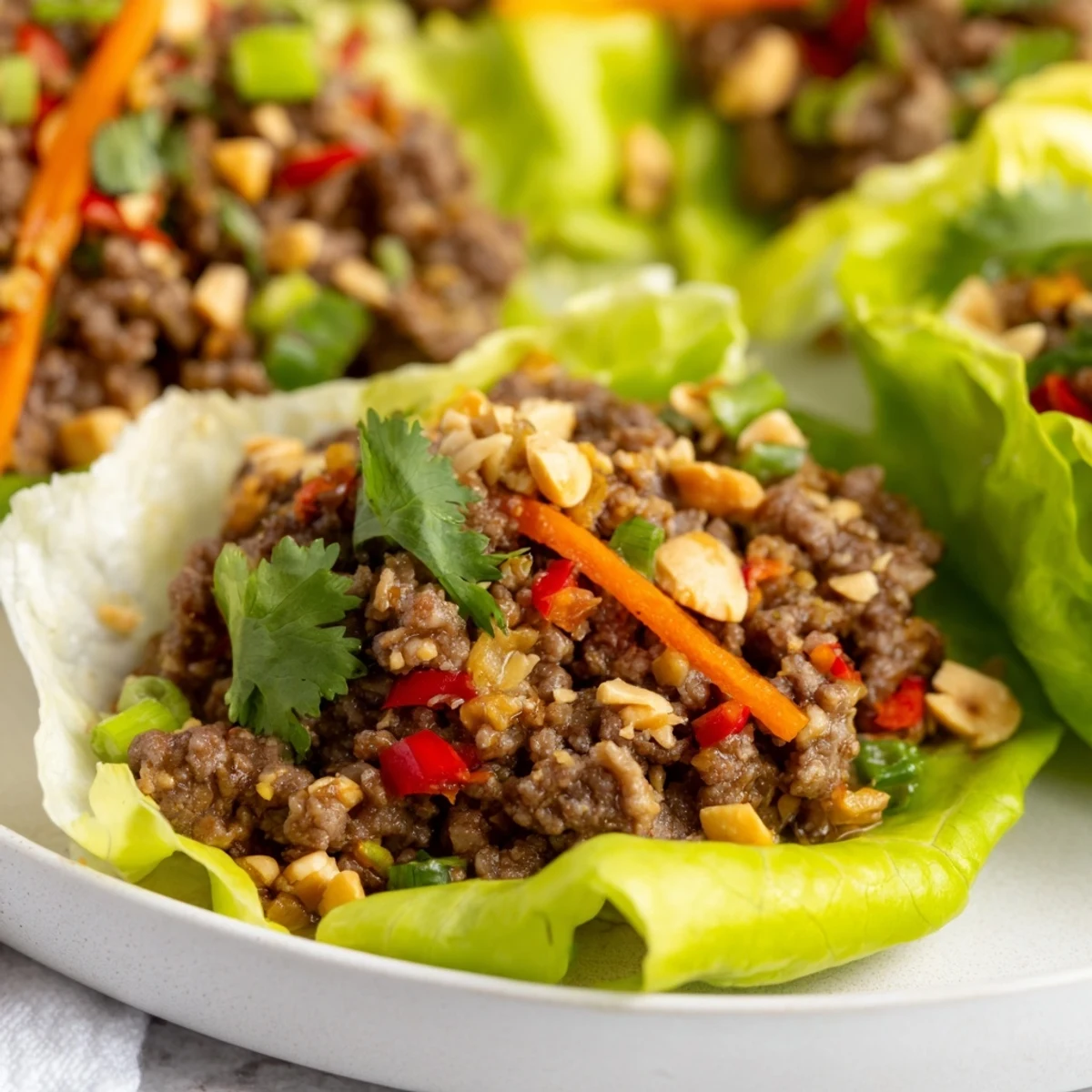Crisp lettuce cups hold flavorful Beef Lettuce Cups ready for a delicious, healthy meal.