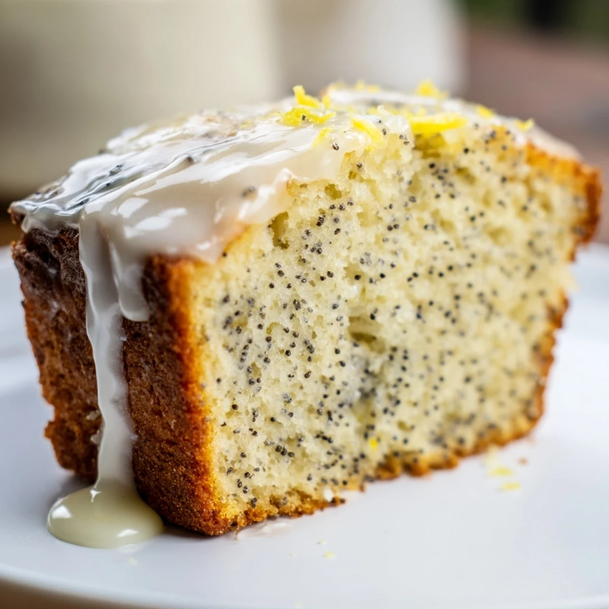 Fluffy Lemon Poppy Seed Loaf with a glistening lemon glaze, perfect for a spring dessert.