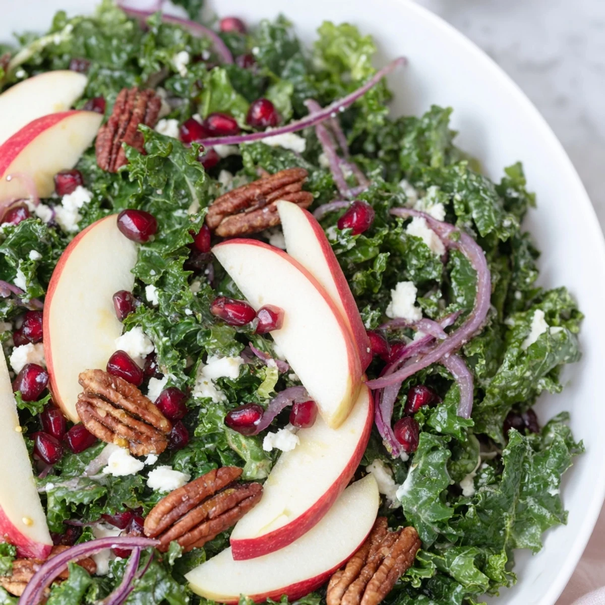Bright Winter Kale Salad with pomegranate seeds and toasted pecans for a flavorful side.