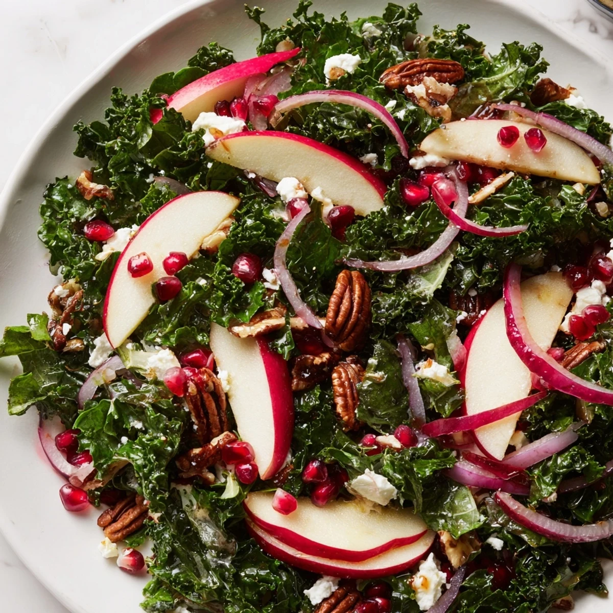Fresh Winter Kale Salad boasting juicy pomegranate, apple slices, and zesty citrus dressing.