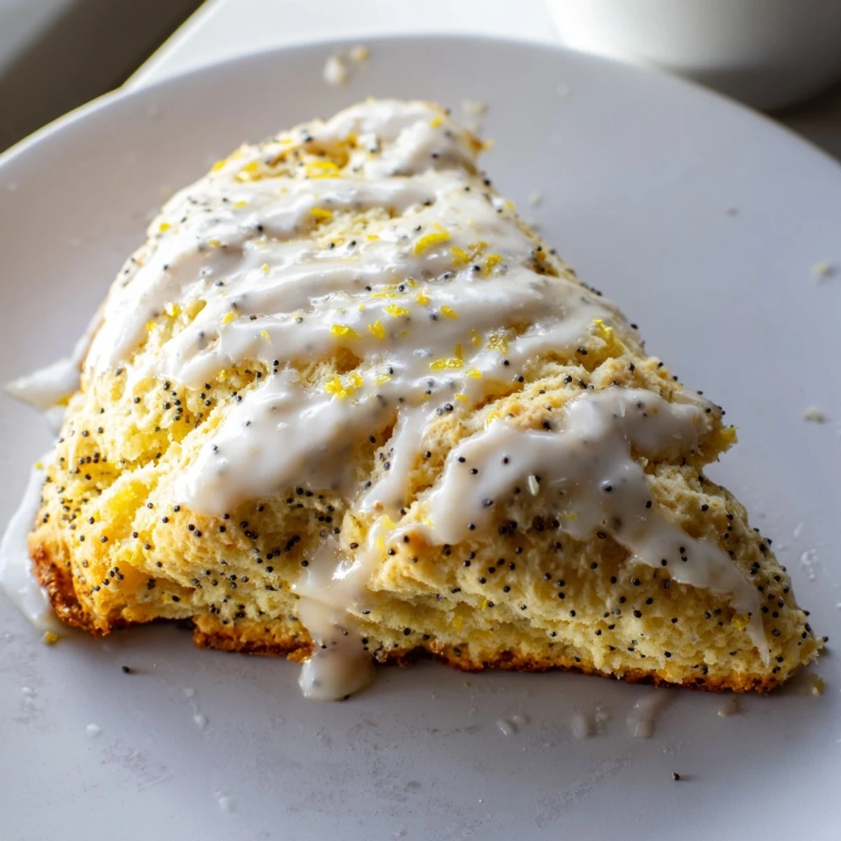 Six golden Lemon Poppy Seed Scones stacked on a rustic wooden board, dusted with poppy seeds and ready for an afternoon tea service.