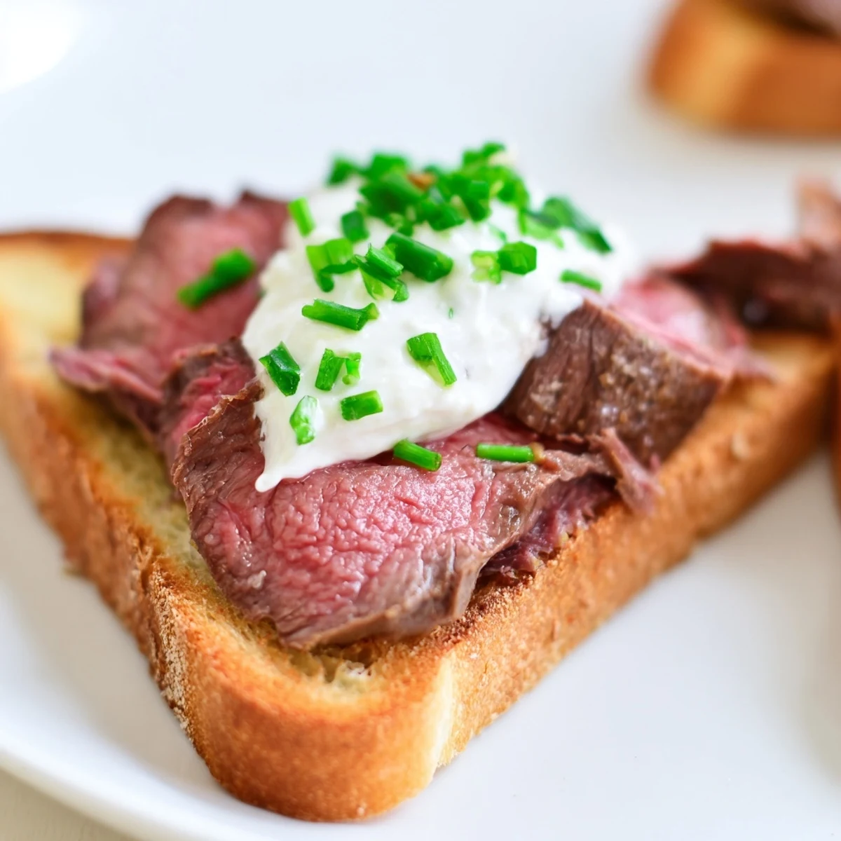 Golden, crisp Beef Toast Points are elegantly topped with tender seared beef and creamy horseradish sauce.