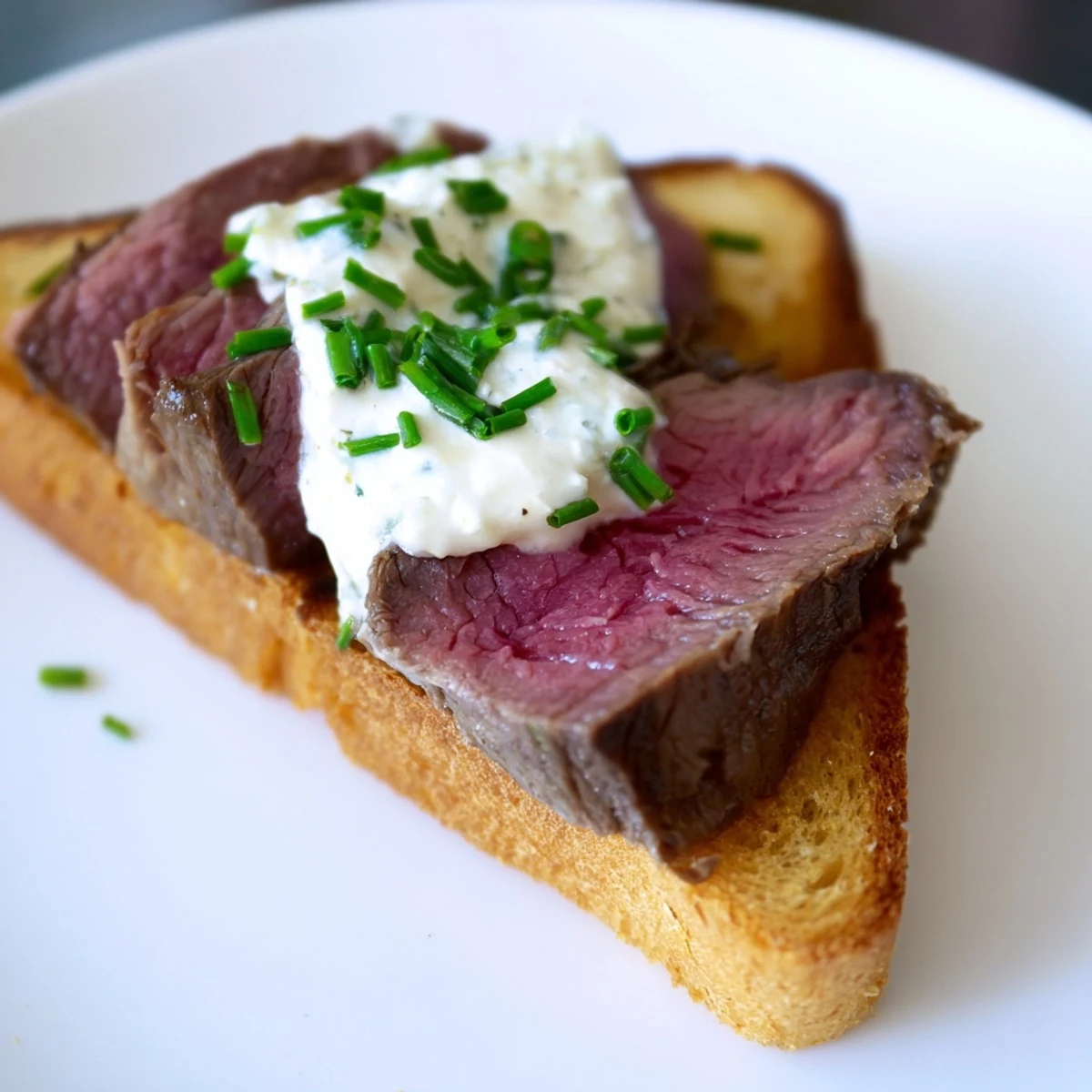 Savory seared beef slices rest on buttery Beef Toast Points with a dollop of zesty horseradish cream.