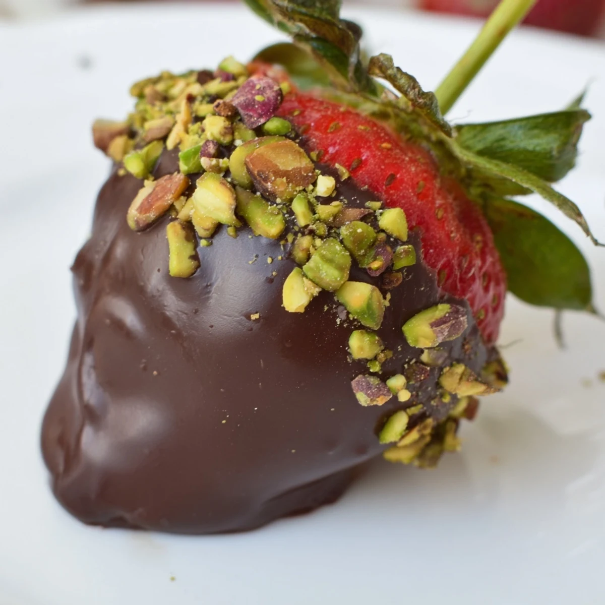 Close-up of Chocolate Dipped Strawberries with Nuts showing juicy berries, rich chocolate, and crunchy pistachios.