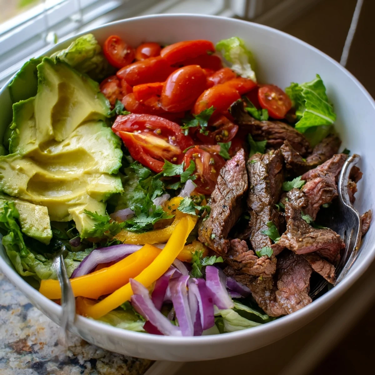 Served in a rustic bowl, the Beef Fajita Salad offers a satisfying meal with tender meat, crunchy vegetables, and a bright drizzle of honey-lime vinaigrette.