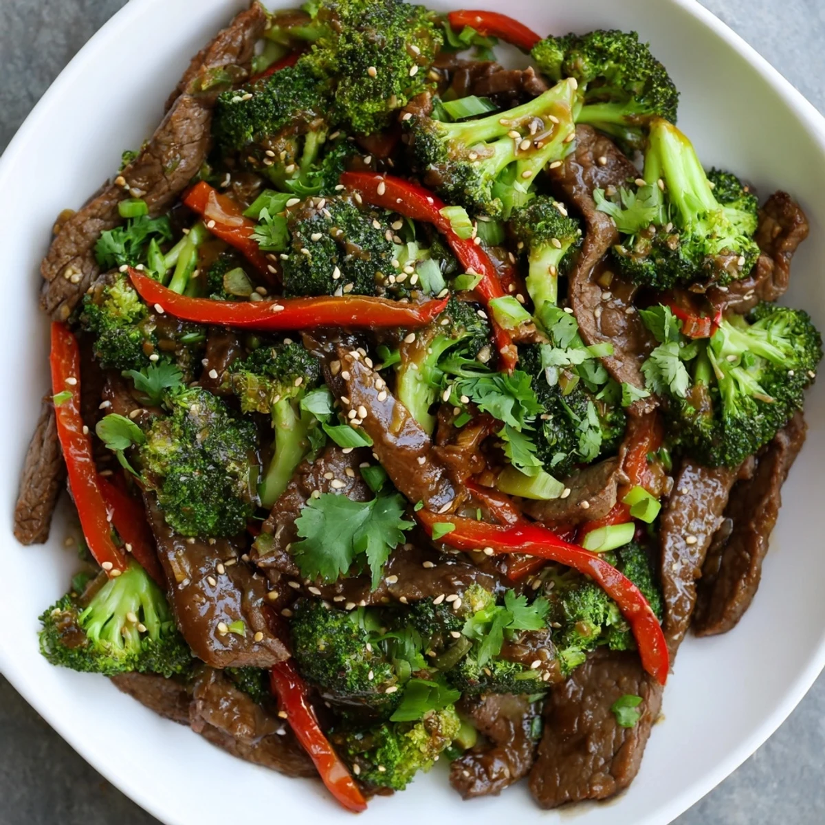 Close-up of Spicy Beef and Broccoli Stir Fry highlighting glossy, savory sauce coating the colorful vegetables.