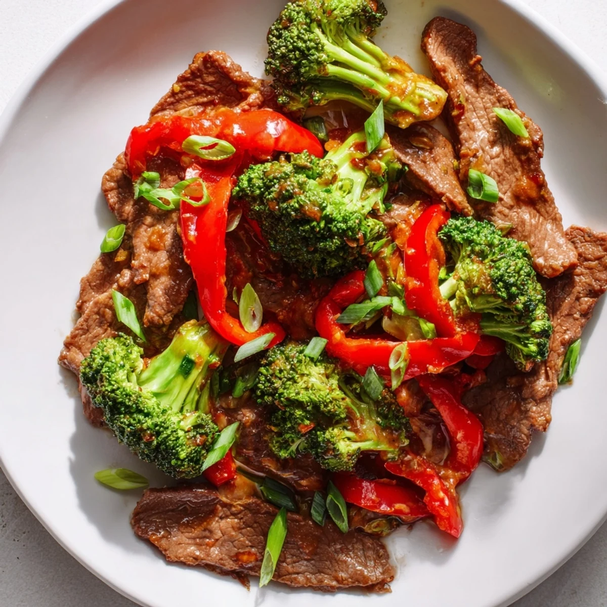 Close-up of tender beef and crisp broccoli coated in a glossy, spicy sauce for dinner.