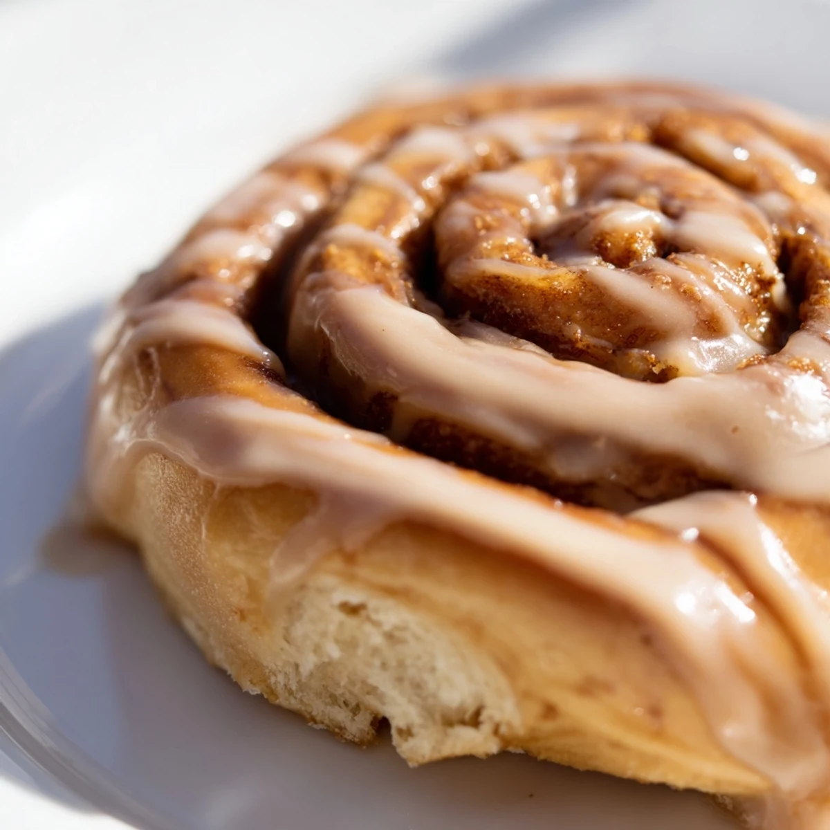 Warm Soft and Gooey Biscoff Cinnamon Rolls with melted cookie spread filling and golden brown edges.