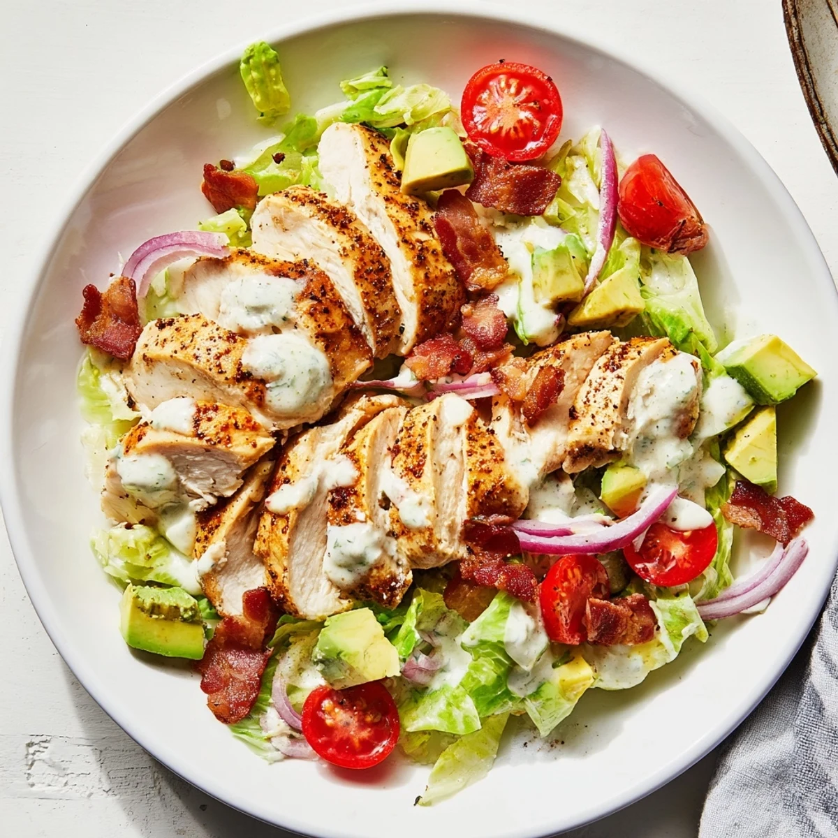 This BLT Chicken Salad features tender chicken, crunchy bacon, ripe cherry tomatoes, and fresh avocado tossed in a tangy yogurt dressing.
