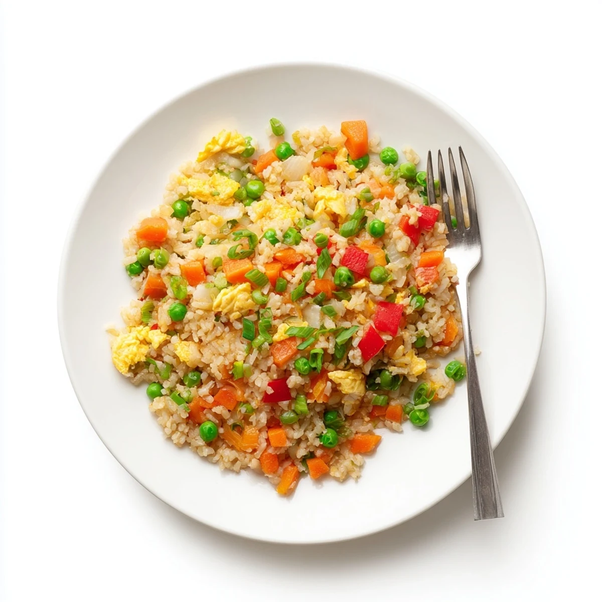 Steaming Fried Rice sizzling in a wok, with scrambled eggs and diced red bell pepper mixed into the savory dish.
