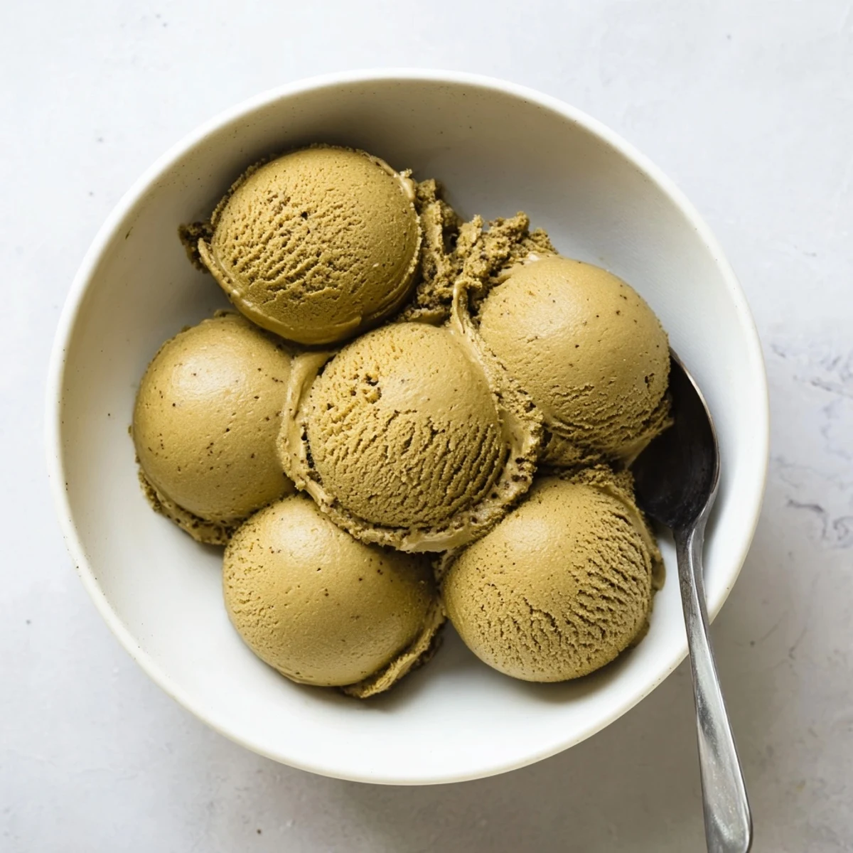 A freshly churned bowl of Hojicha Ice Cream with a smooth, nutty texture and deep roasted aroma.