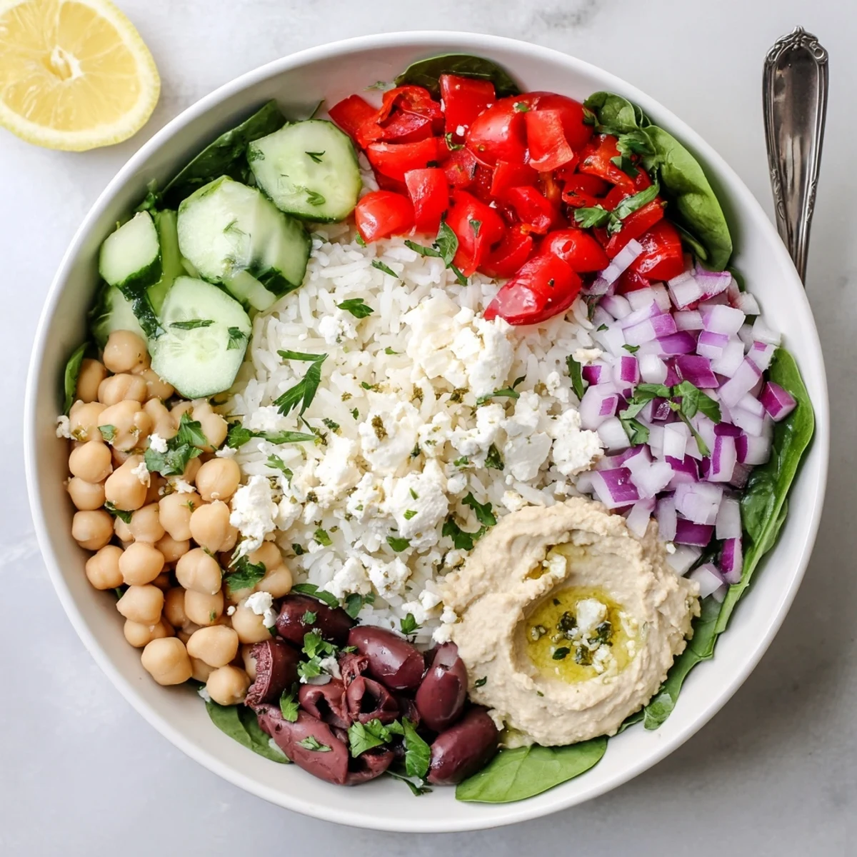 Healthy Mediterranean rice bowl arranged with colorful vegetables, protein-rich chickpeas, and tangy feta cheese topping