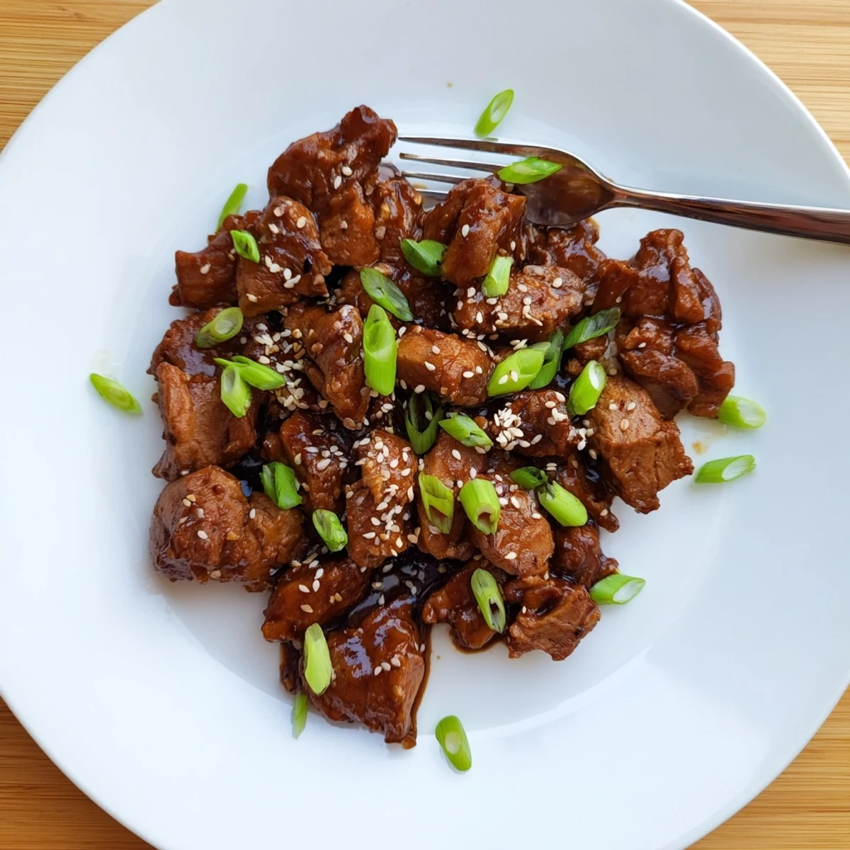 Slow cooker Mongolian chicken featuring shredded meat glazed in thick savory-sweet sauce over white rice
