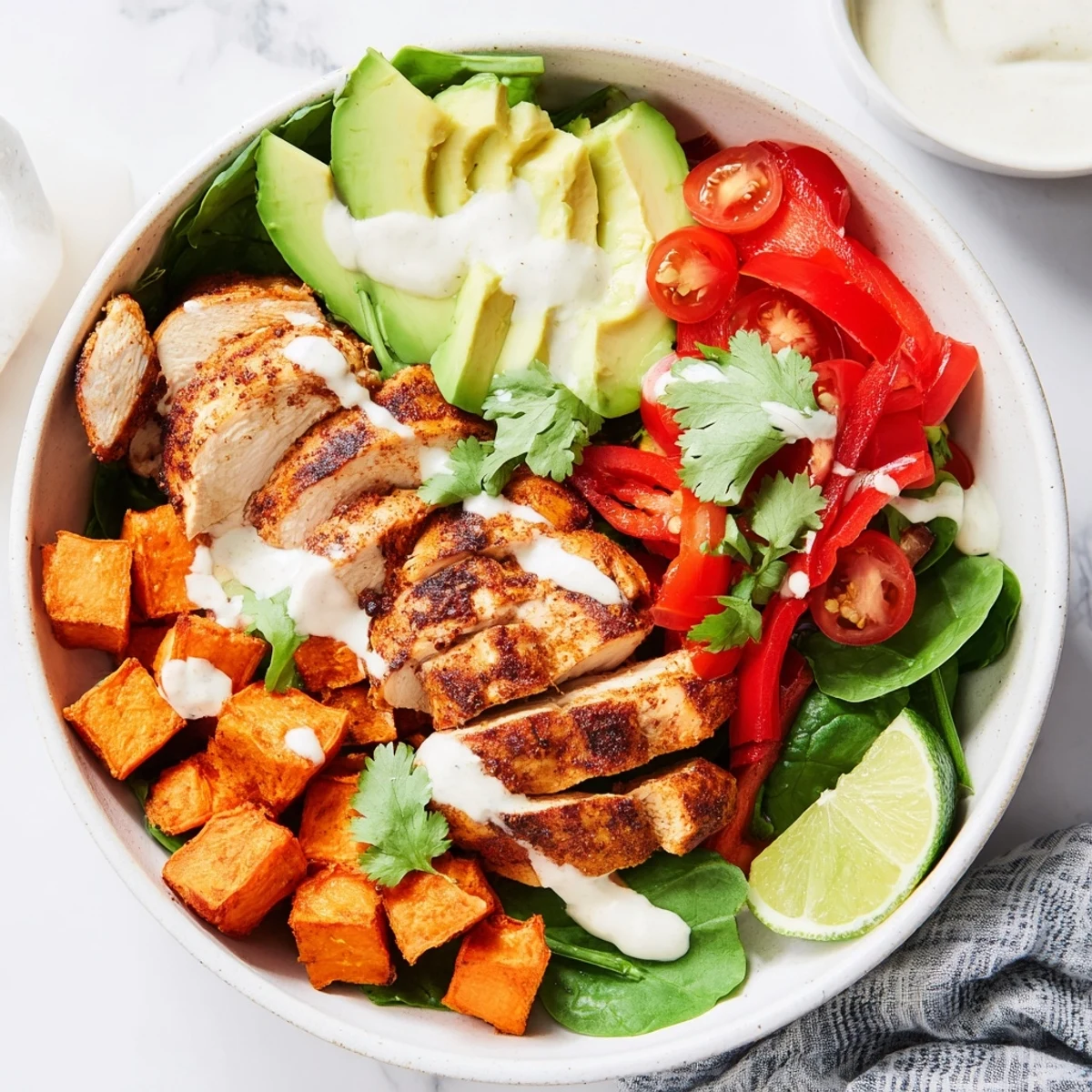 Healthy chicken sweet potato bowl featuring tender spiced chicken, caramelized sweet potato cubes, and vibrant bell pepper