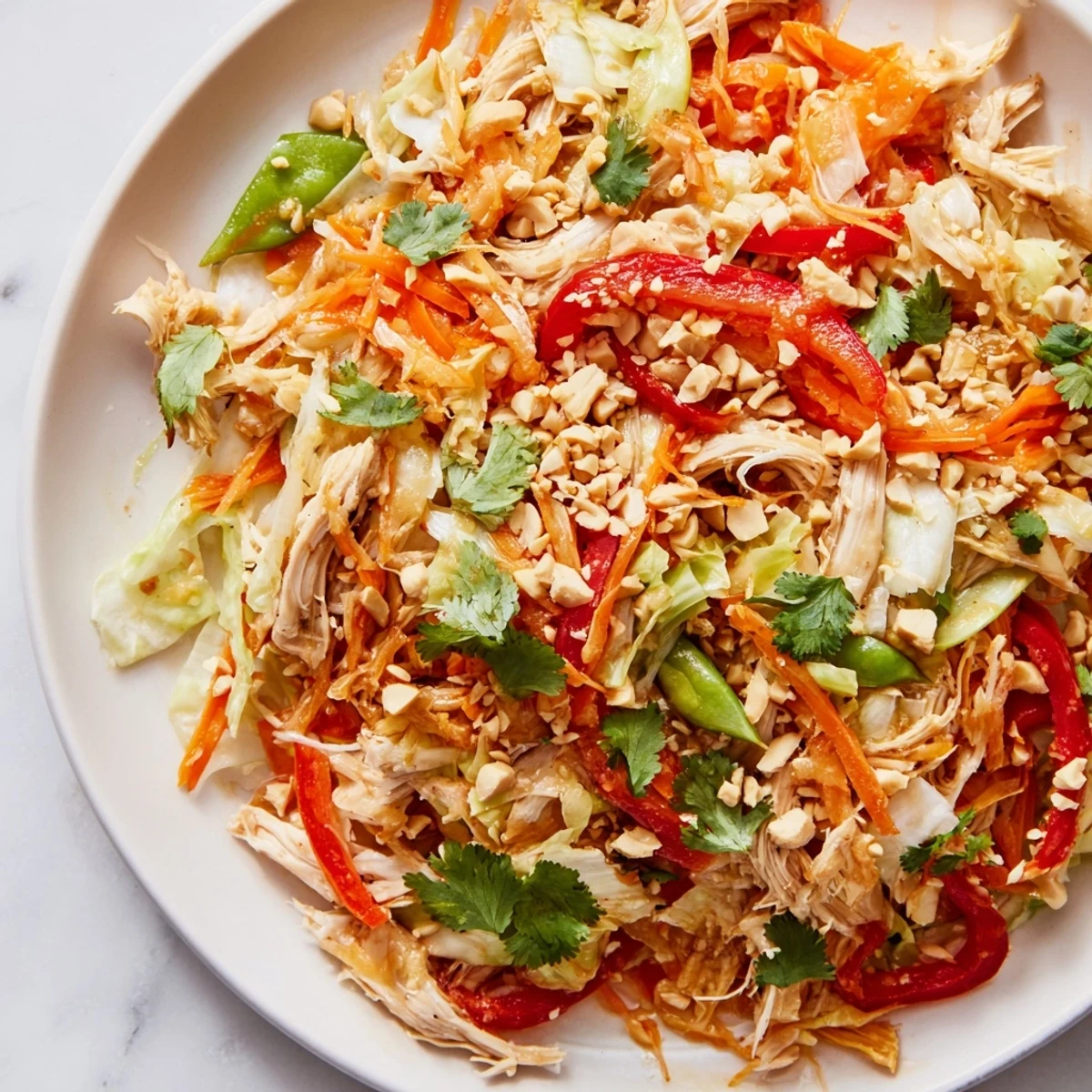 Colorful no cook Asian chicken salad with crisp vegetables in sesame-ginger dressing