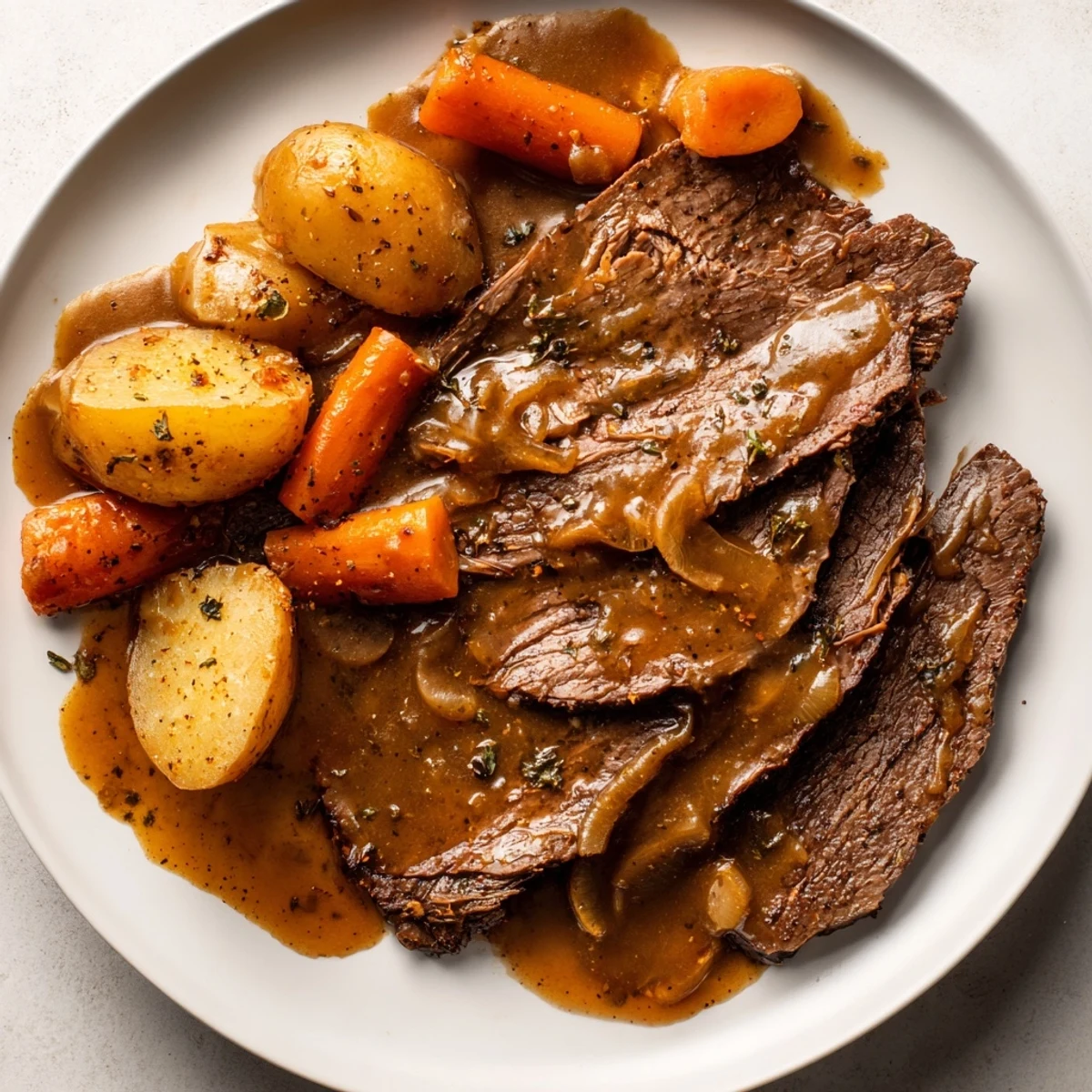 Slow-cooked Southern style pot roast plate served with buttery vegetables and thick savory gravy