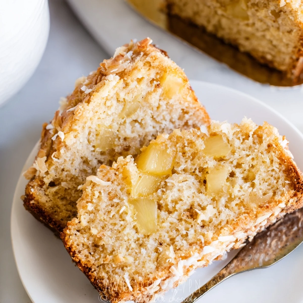 Warm pineapple coconut bread loaf sliced to reveal tender fruit-filled interior texture