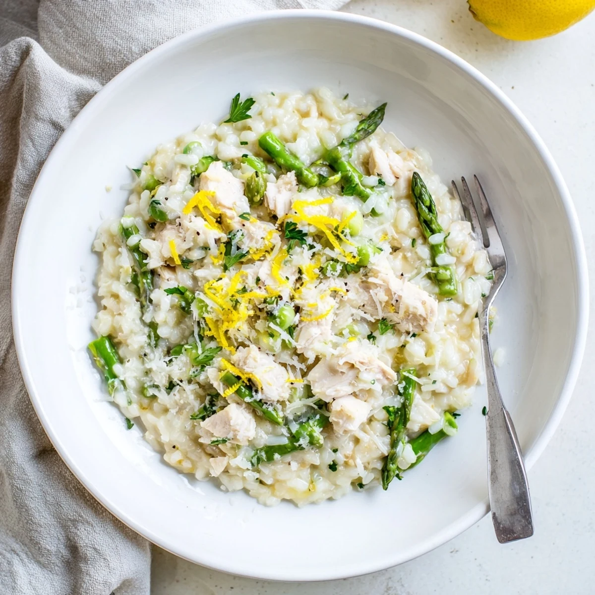 Golden brown chicken pieces mixed with tender green asparagus spears in a rich Italian Arborio rice dish