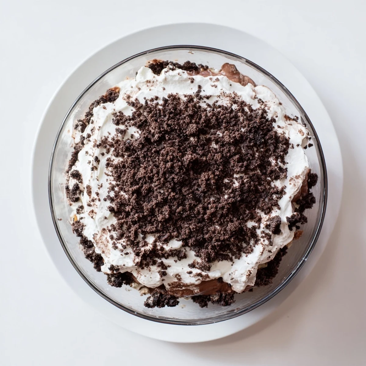 Rich low-carb dirt cake featuring fluffy whipped cream layers topped with chocolate almond crumble