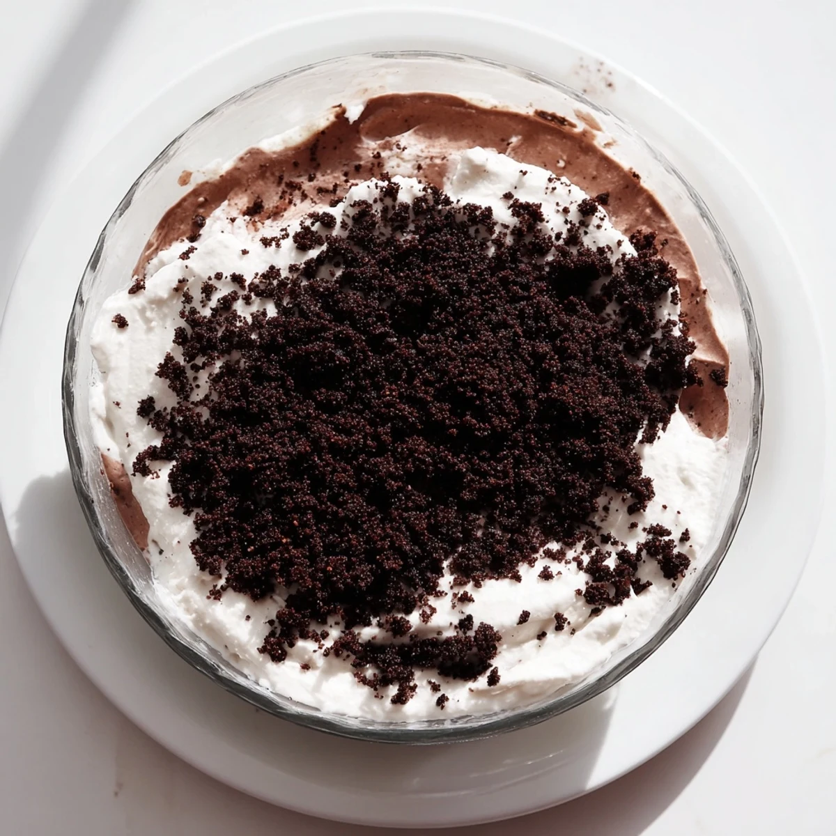No-bake keto dirt cake dessert with chocolate pudding, whipped cream, and crunchy dirt topping