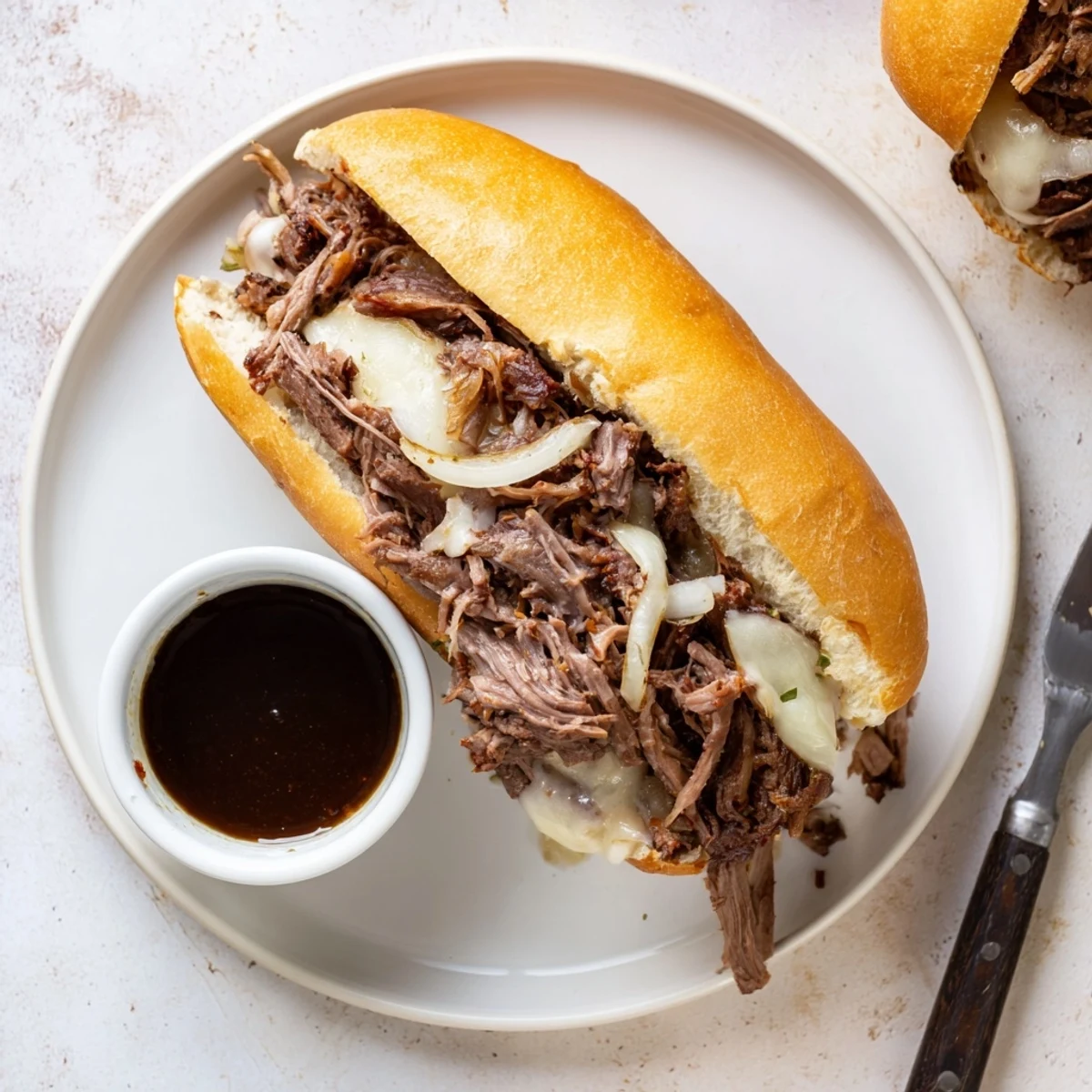 Golden shredded beef piled onto toasted hoagie rolls with melted provolone cheese in these Crockpot French Dip Sandwiches