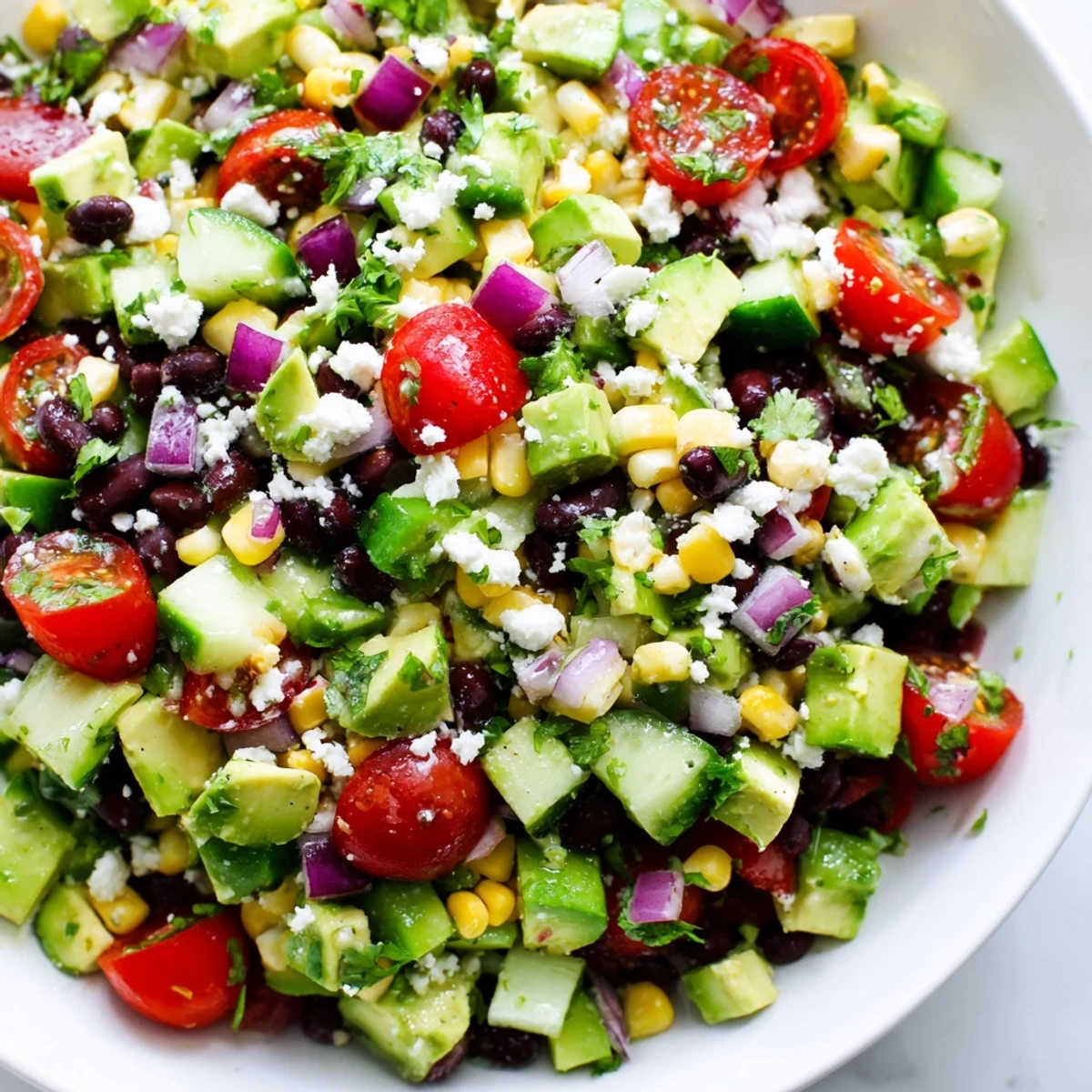 Colorful Mexican chopped salad in a rustic bowl with fresh vegetables and creamy avocado