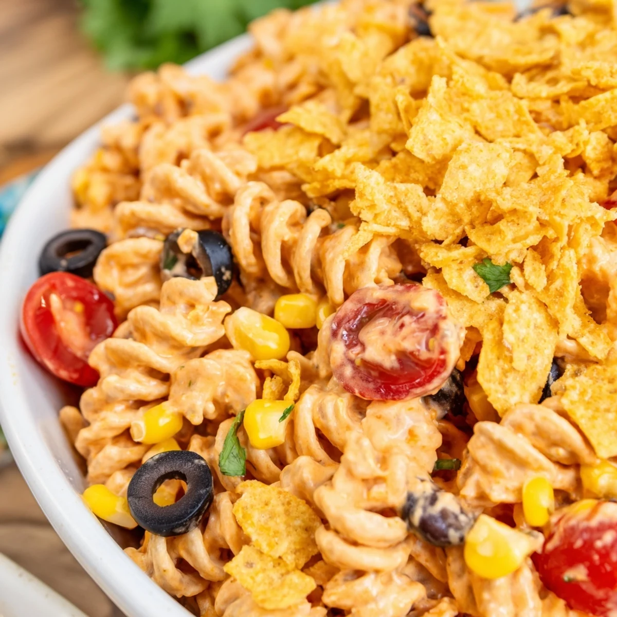 Colorful Taco Pasta Salad loaded with fresh vegetables and creamy zesty dressing in a serving bowl