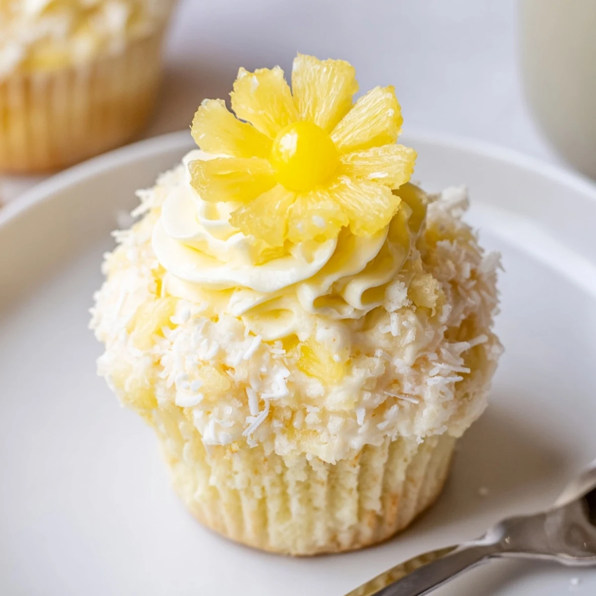 Dole Whip Cupcakes Recipe: fluffy pineapple cupcakes topped with creamy swirl and cherry