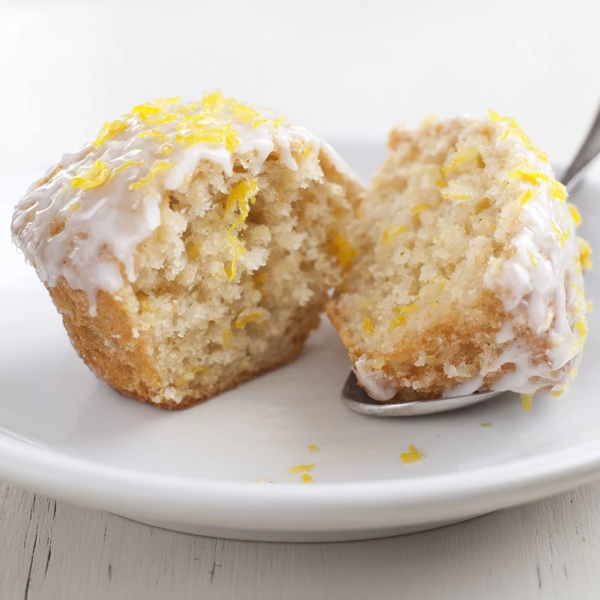 Fresh-baked Glazed Lemon Ginger Muffins served with tea, tangy sweet glaze  