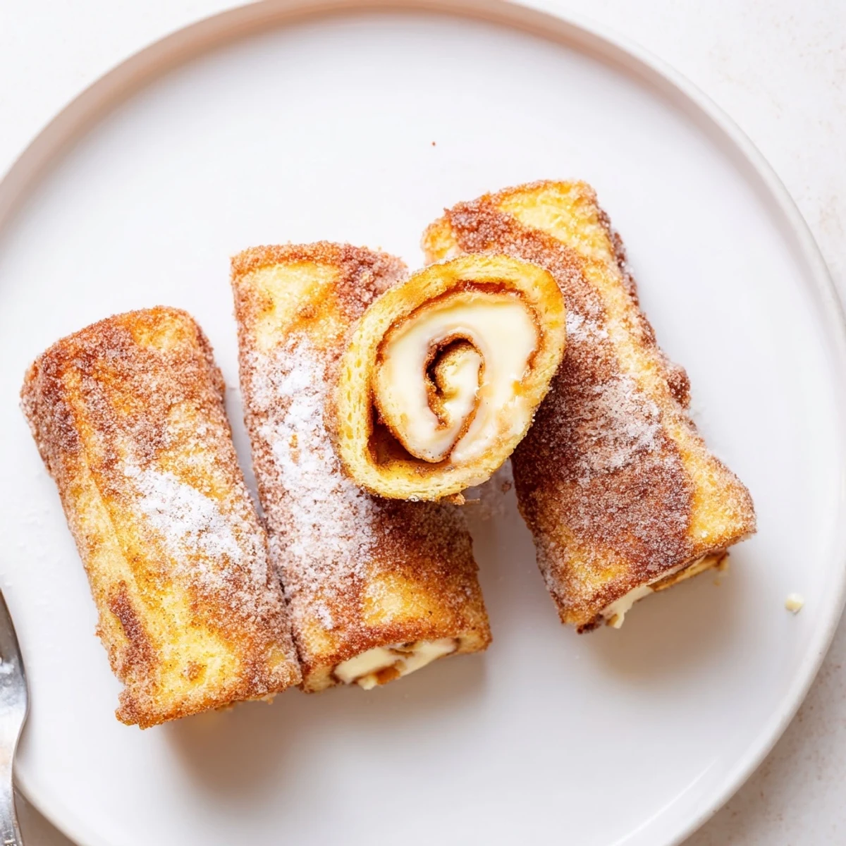 Cinnamon Roll French Toast Roll Ups served warm on brunch platter with syrup