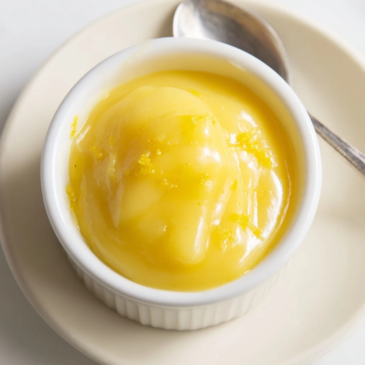Lemon Curd Recipe: glossy, buttery yellow spread cooling in mason jar