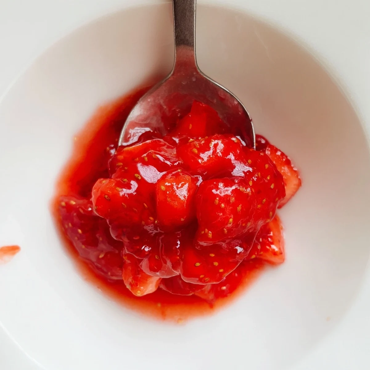 Warm Strawberry Cake Filling Recipe spooned between vanilla cake layers, sweet and tart aroma