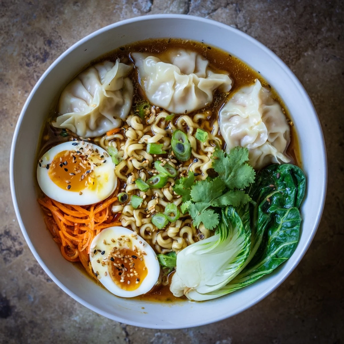 Steaming bowl of dumpling ramen with creamy soft-boiled eggs, fresh spinach, and shredded cabbage
