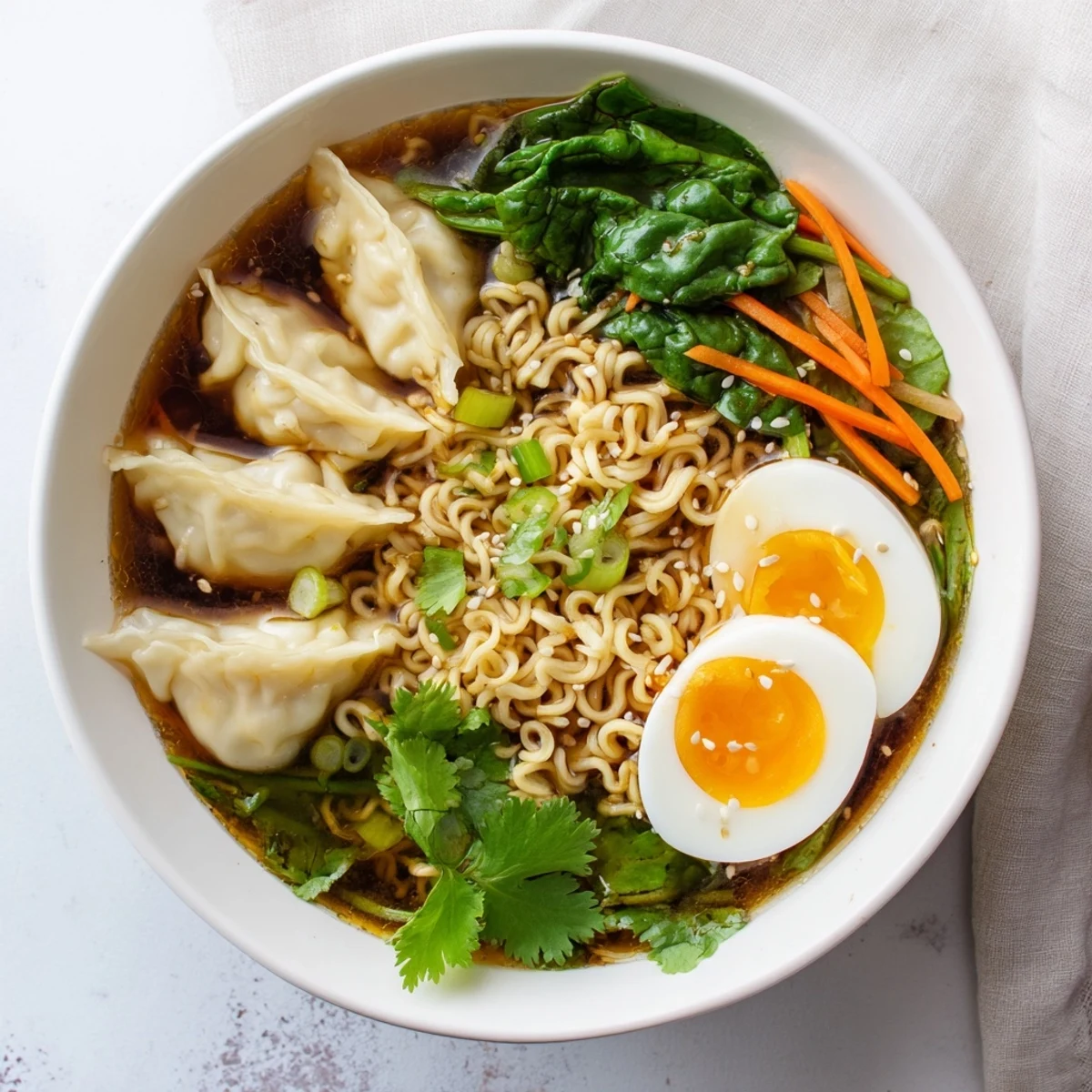 Savory dumpling ramen bowl featuring soft-boiled eggs and vibrant fresh greens in aromatic broth
