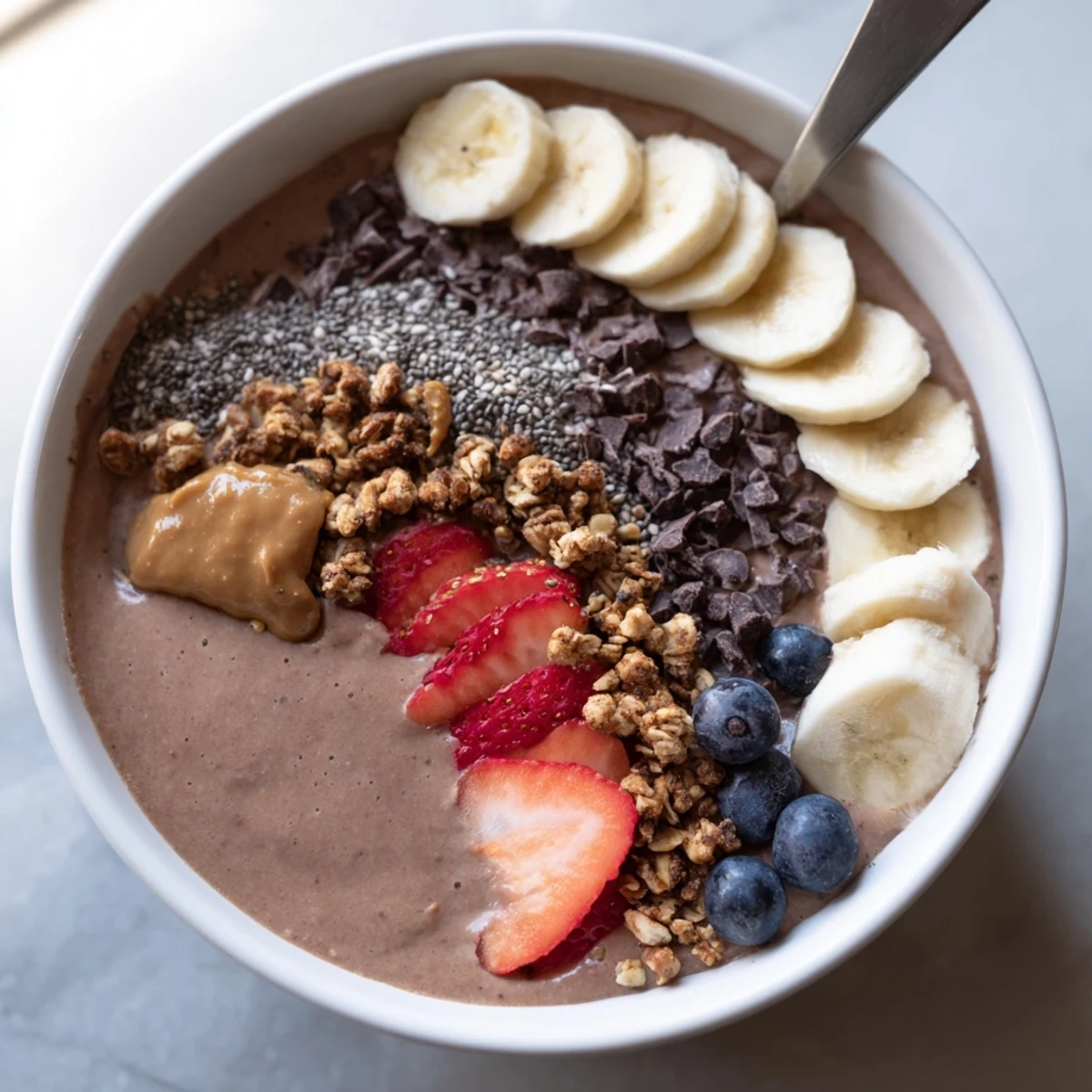 Nutty, cocoa-tinged Coffee Protein Smoothie Bowl recipe garnished with chia seeds