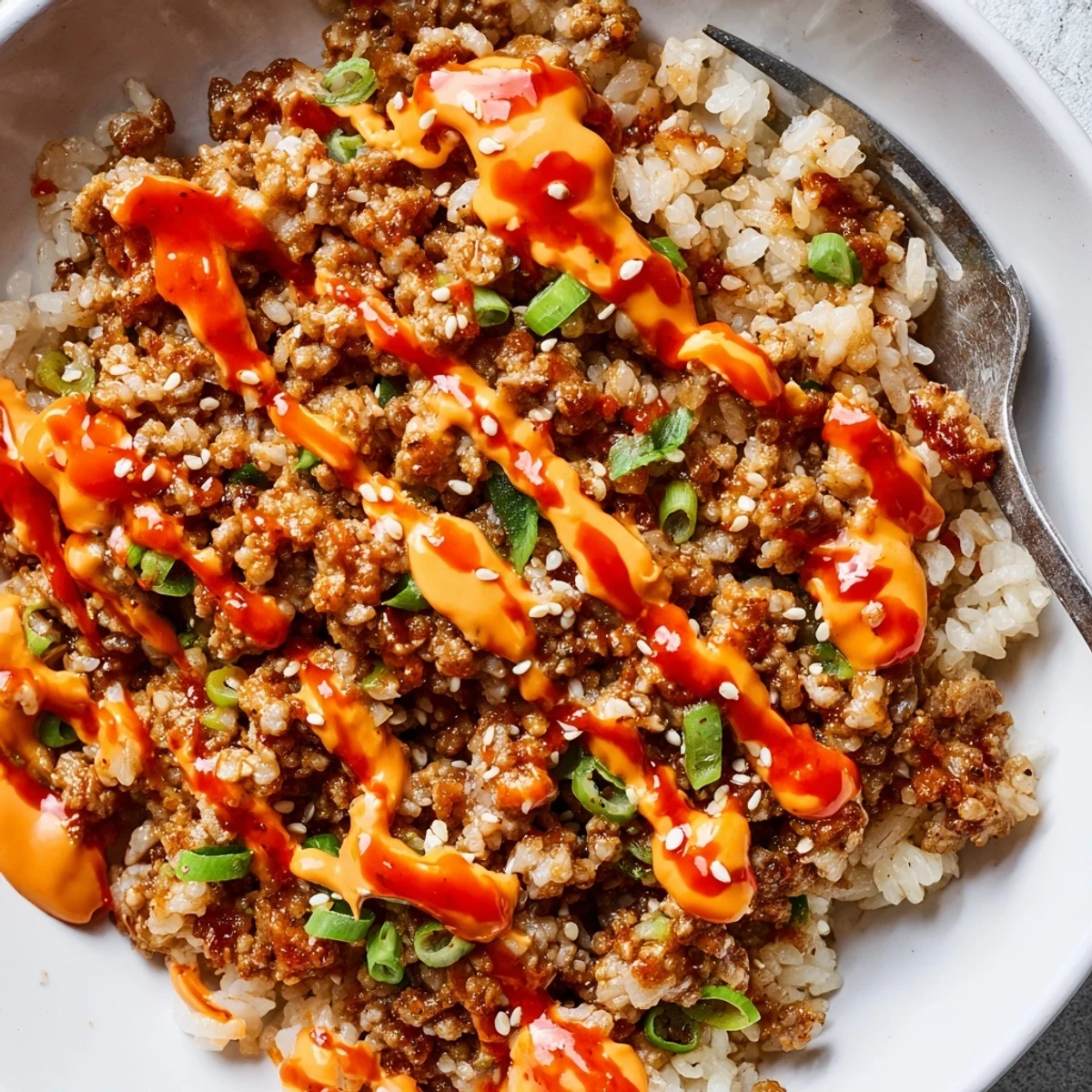 Ground Turkey Rice Bowls drizzled with spicy creamy Bang Bang sauce over jasmine rice