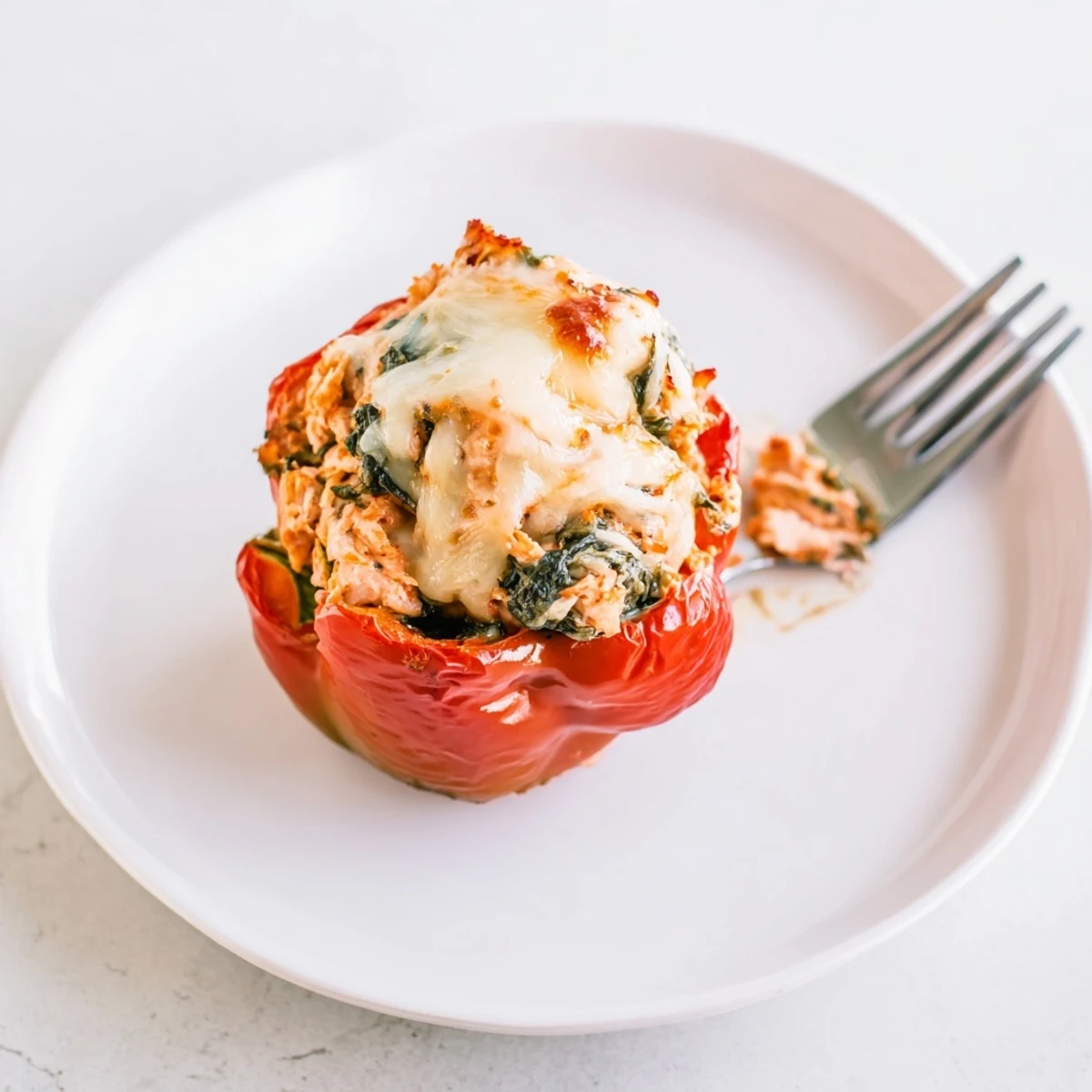 Golden brown Chicken Florentine Stuffed Peppers overflowing with savory chicken and spinach filling  