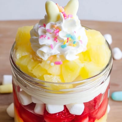 A close-up of Jello Pie Easter Bunny Parfait In A Jar showing lemon gelatin cubes with pineapple and mini marshmallows