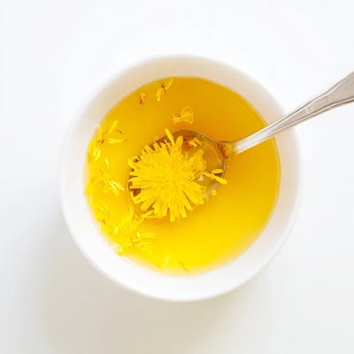 Warm homemade fresh dandelion jelly glistening in a sunlit mason jar