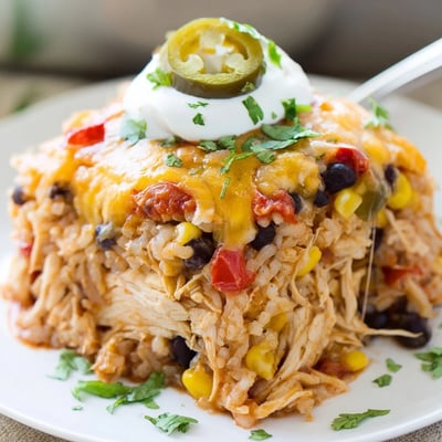 Creamy chicken burrito casserole with black beans rice and gooey Monterey Jack